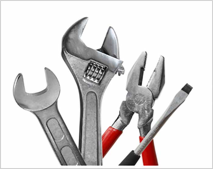 Various plumbing tools including wrenches and screwdrivers