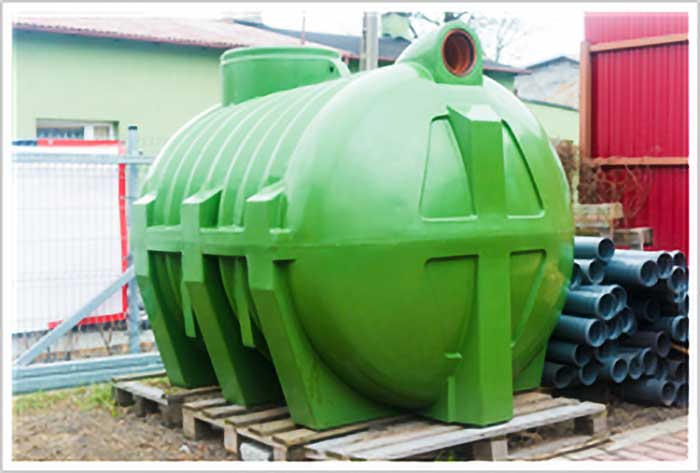 Bright green septic tank sitting on a wood pallet.